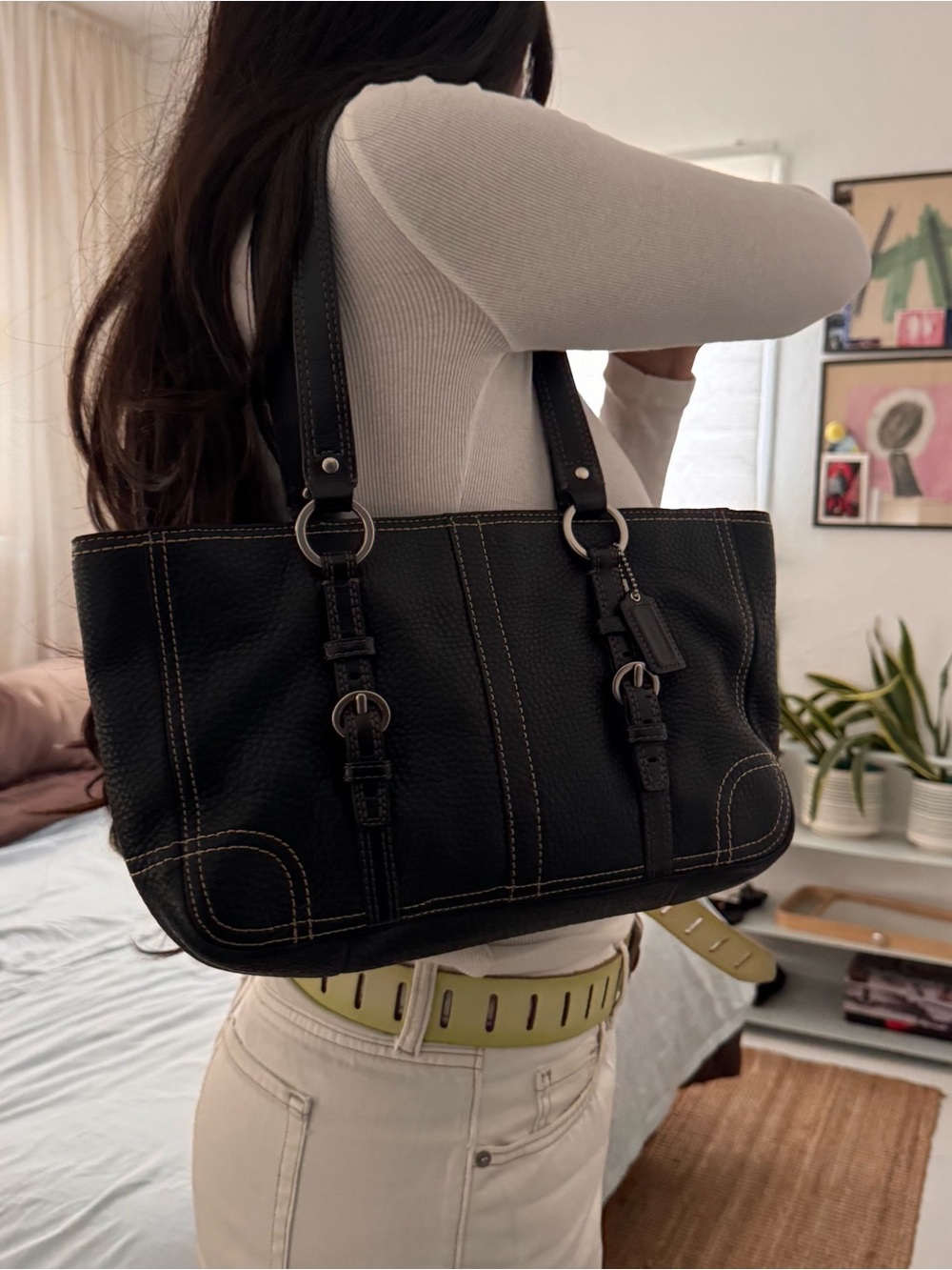 Black Coach leather buckle handbag with silver hardware